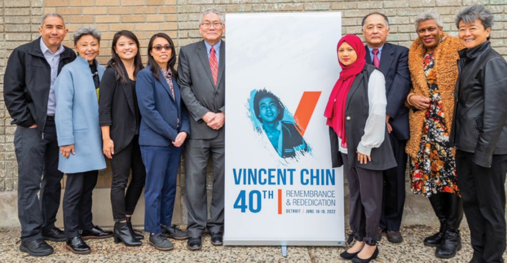 Members of ACJ posing with a banner reading "Vincent Chin 40th Remembrance and Rededication." From left to right, Don Young, Debra Nakatomi, Amy Watanabe, Zosette Guir, Roland Hwang, Rebeka Islam, James Shimoura, Rochelle Riley, Helen Zia. Courtesy of the collections of Helen Zia and the Vincent and Lily Chin Estate. 